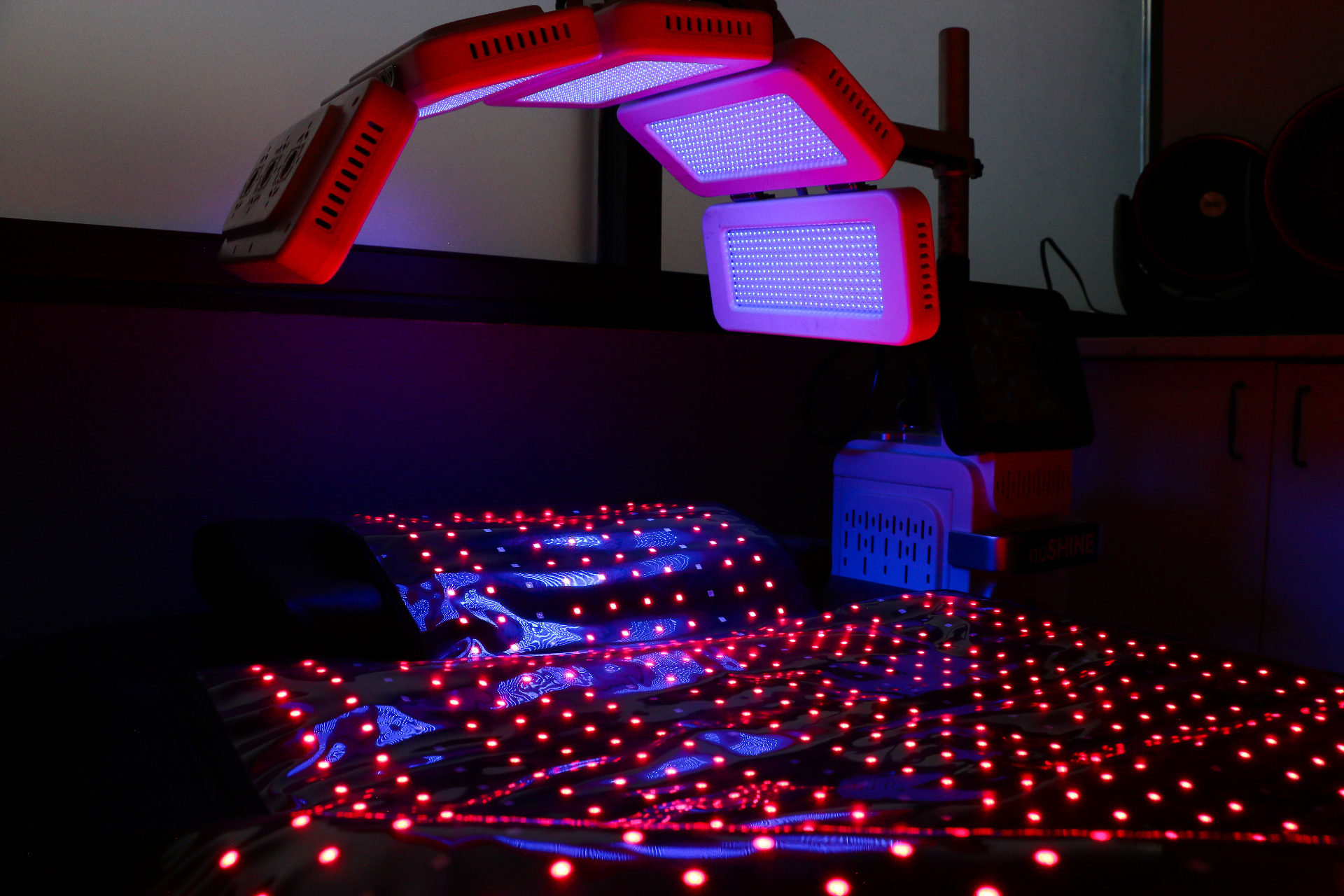 Close-up of Ascent red light therapy bed and LED panels in treatment